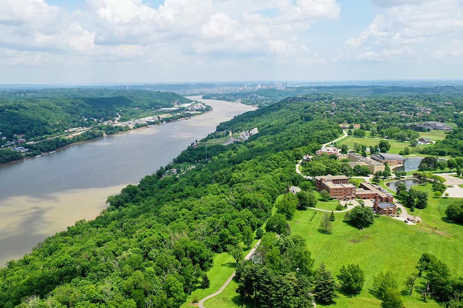 Portsmouth, OH Insurance - Aerial View of the Ohio River on a Sunny Day, Green Trees Lining the River